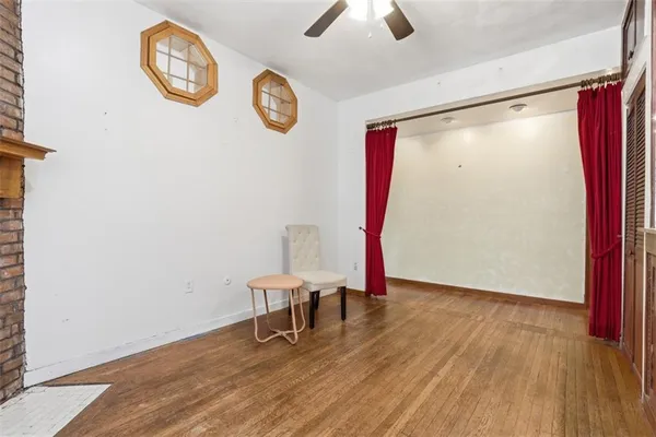 a bedroom with furniture and a large window