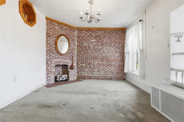 a view of a livingroom with furniture and a window