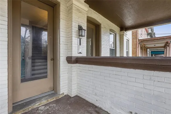 a view of a brick house with entryway