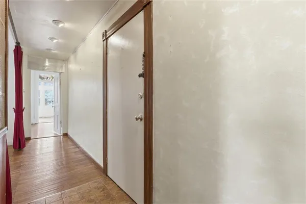 a view of a hallway with wooden floor