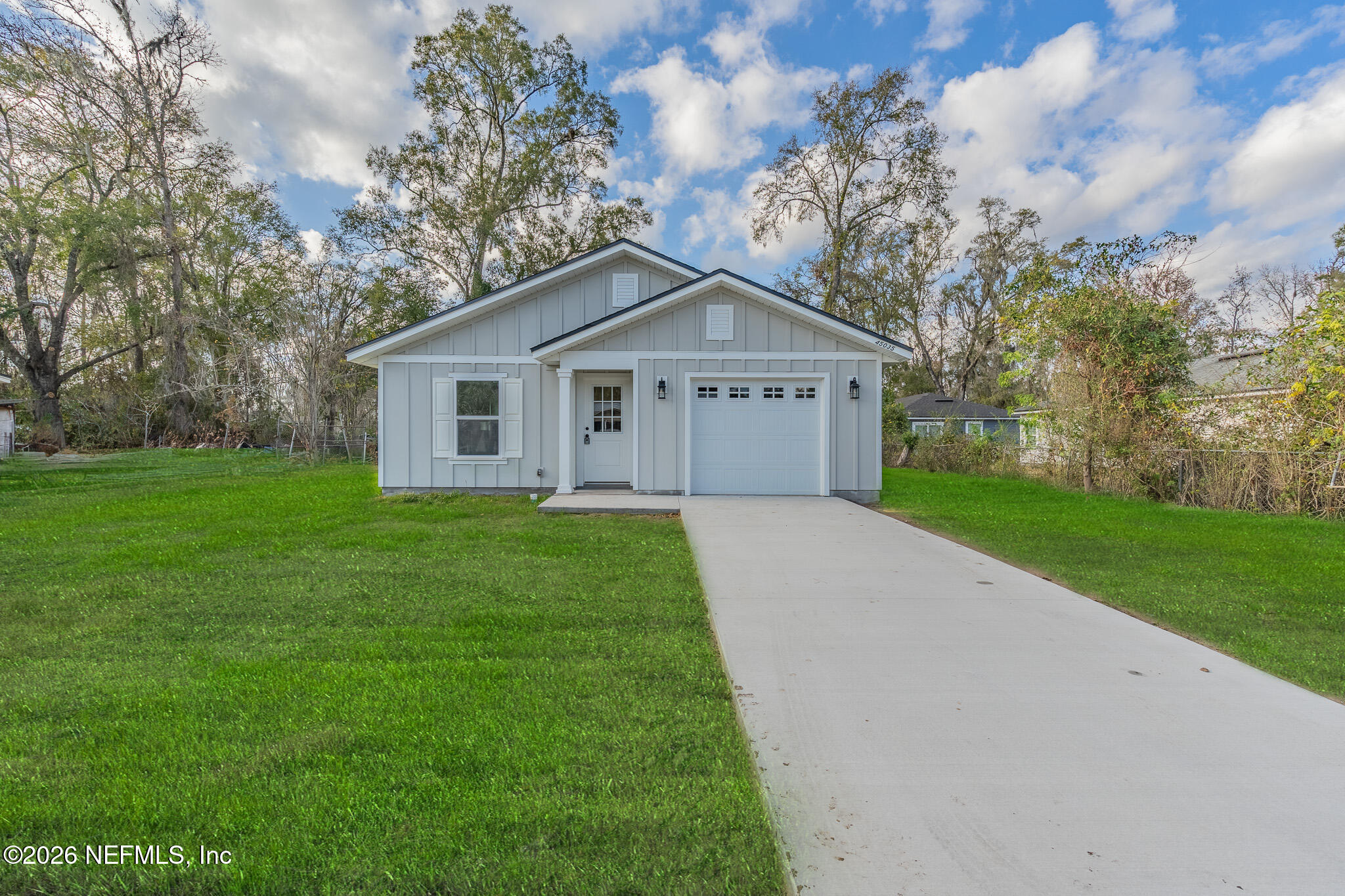 a front view of house with yard and green space