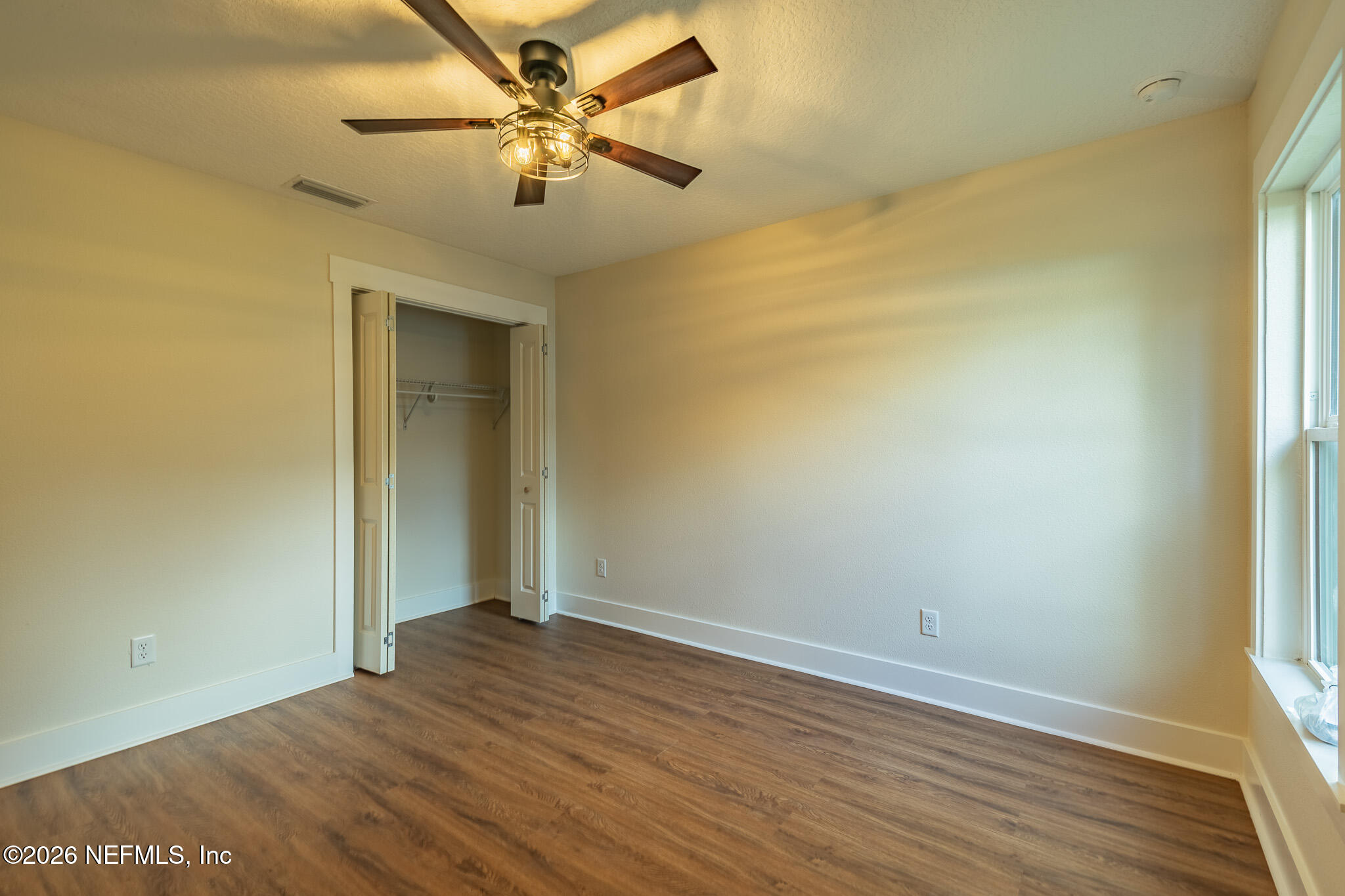 45035 James Street Callahan, FL 32011 - Photo 15 of 21 an empty room with a window and a ceiling fan