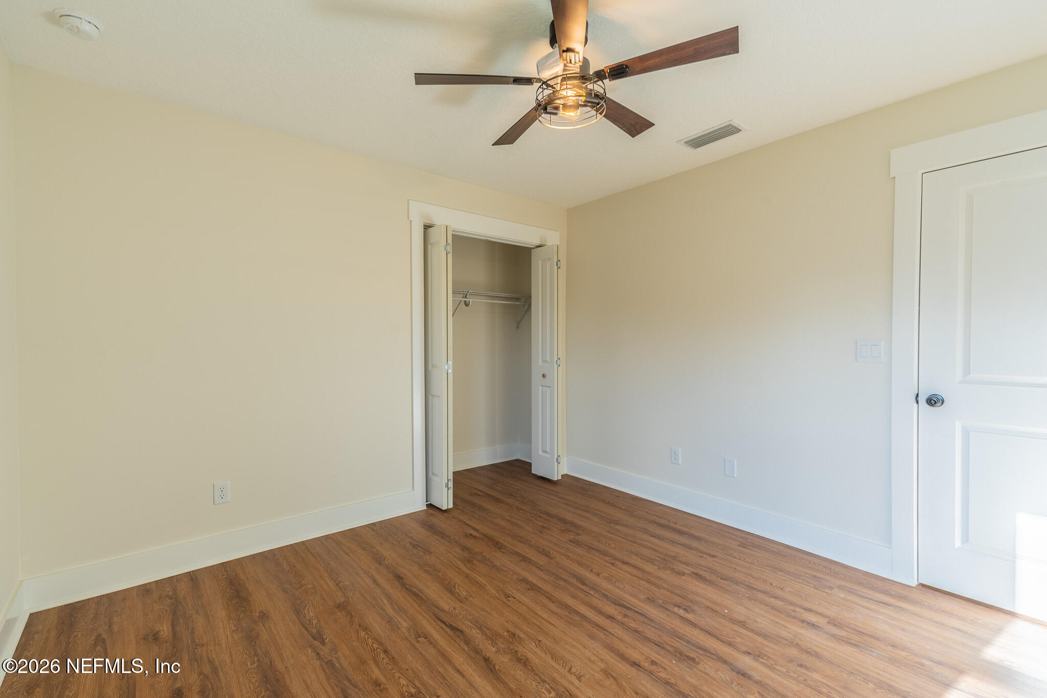 45035 James Street Callahan, FL 32011 - Photo 19 of 21 an empty room with wooden floor fan and windows