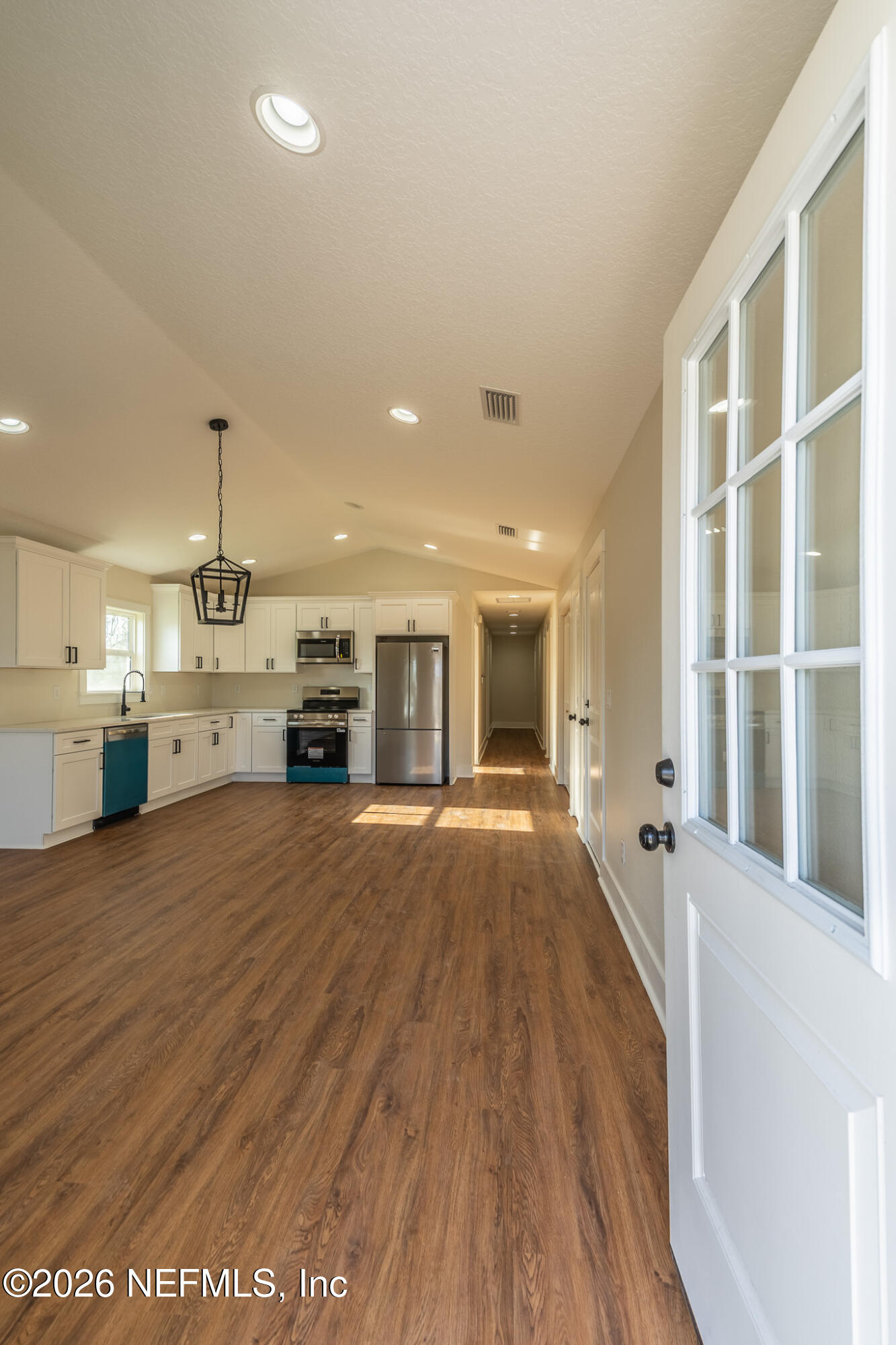45035 James Street Callahan, FL 32011 - Photo 4 of 21 a view of an empty room with a kitchen and a window