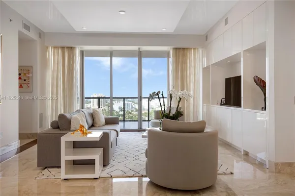 a living room with furniture and a large window
