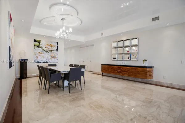 a view of a dining room with furniture and chandelier