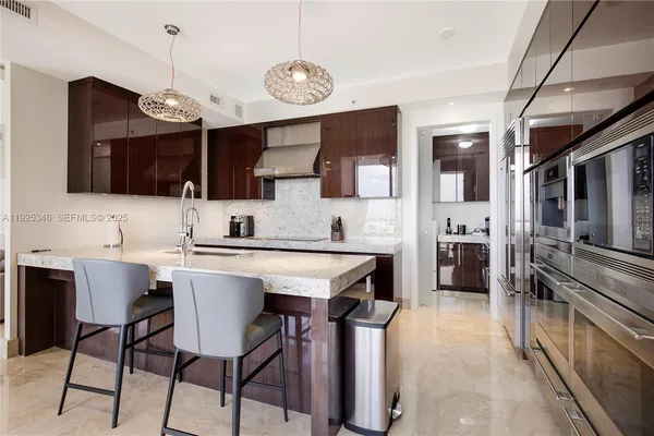 a kitchen with a sink stainless steel appliances and cabinets