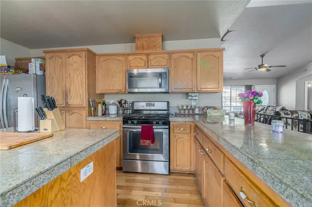 a kitchen with stainless steel appliances granite countertop a sink dishwasher stove and refrigerator