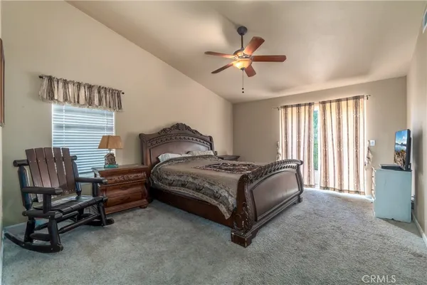 a bedroom with a bed a chair and piano