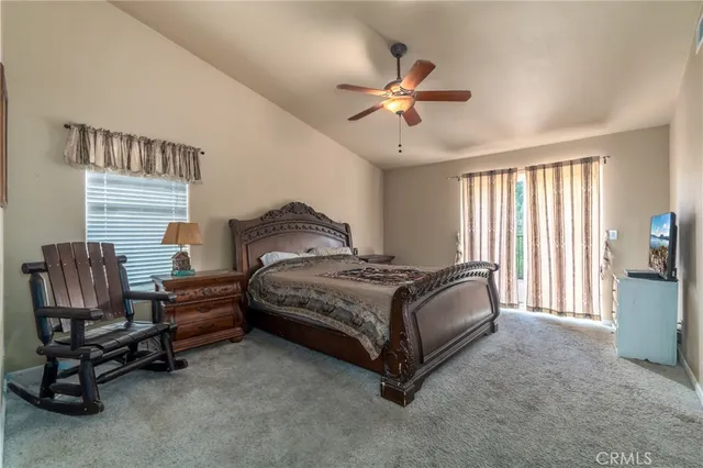 a bedroom with a bed a chair and piano