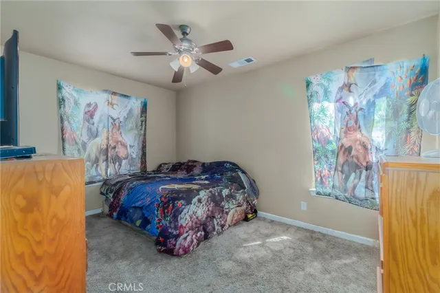 a bedroom with a bed and a painting on the wall