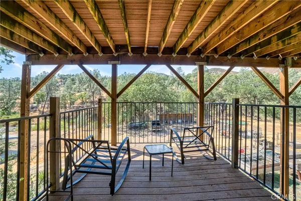 a porch area with wooden floor outdoor seating