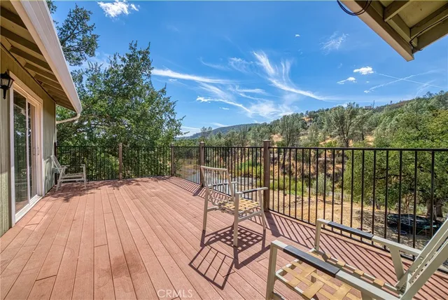 a view of a balcony with wooden floor and outdoor space