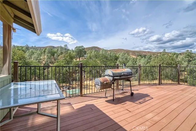 a view of a balcony with wooden floor and iron stairs