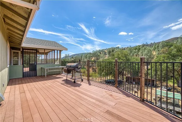 a view of a roof deck with wooden floor and fence