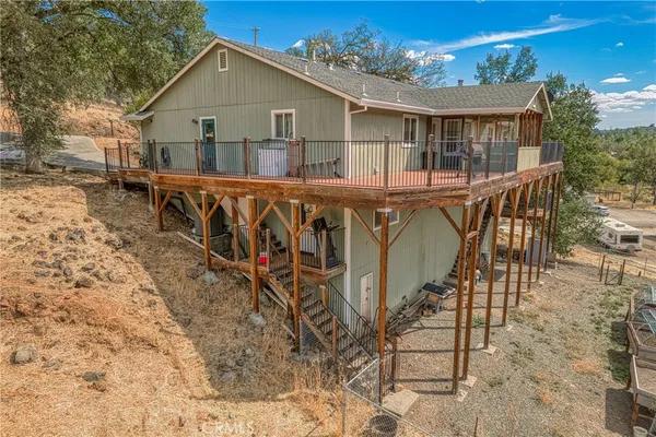 a view of a house with backyard and sitting area