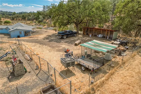 a view of a patio with table and chairs with wooden floor and fence