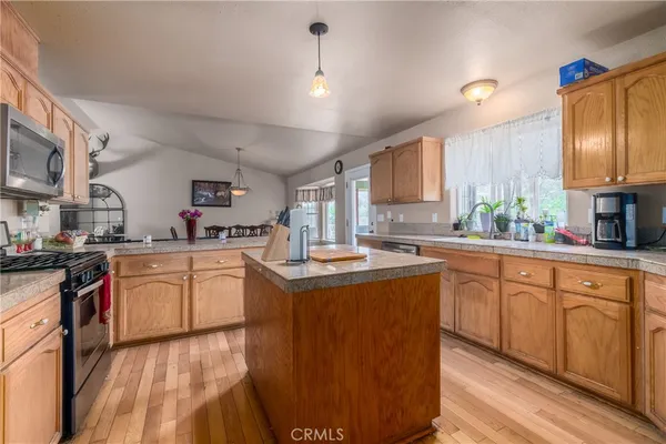 a kitchen with cabinets a sink and appliances