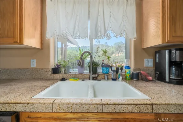 a kitchen with kitchen island granite countertop a sink and a counter top space
