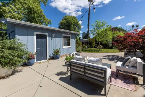 a view of a patio with chair and table in the backyard