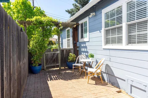 a view of a patio with a table and chairs