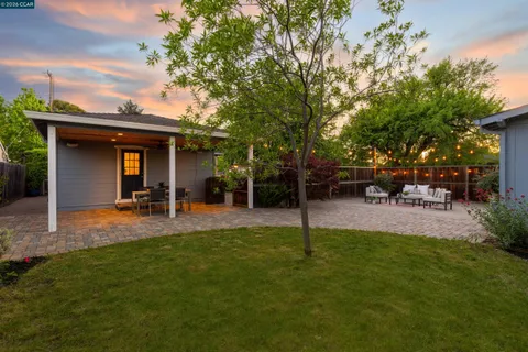a view of a house with a backyard porch and sitting area