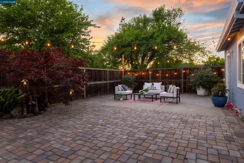 a view of a backyard with sitting area
