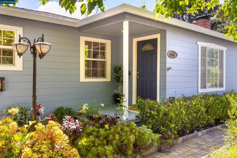 a front view of a house with a yard and fountain