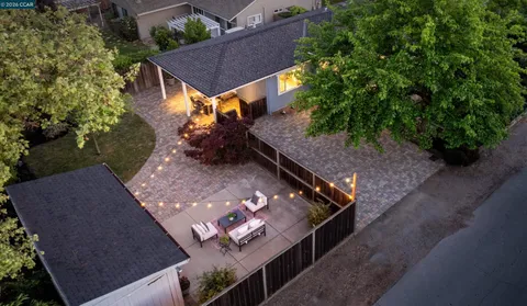 an aerial view of a house with a yard