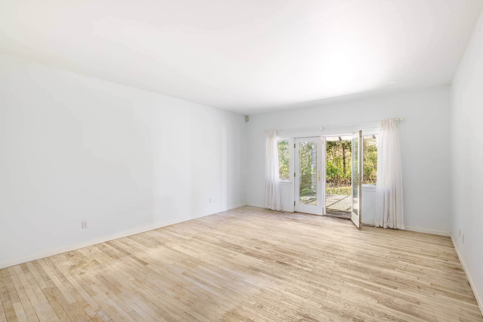 23 Fieldview Lane East Hampton, NY 11937 - Photo 8 of 16 a view of an empty room with wooden floor and a window