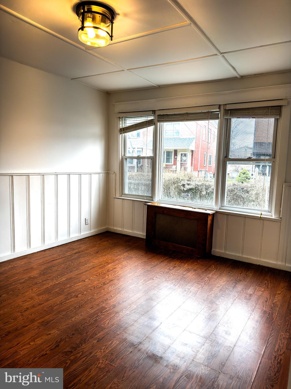 234 Windsor Avenue Upper Darby, PA 19082 - Photo 16 of 28 a view of an empty room with a window and wooden floor