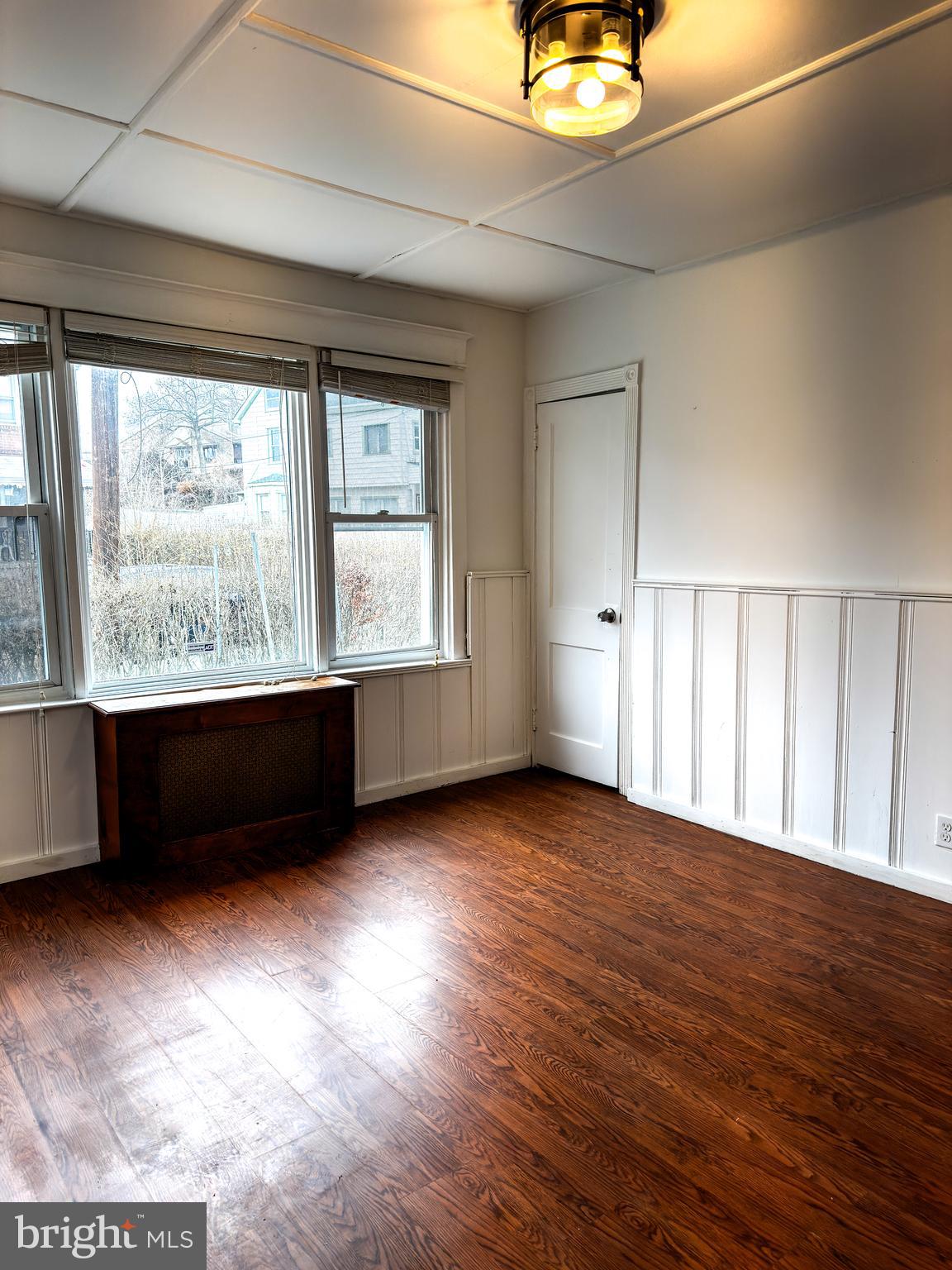 234 Windsor Avenue Upper Darby, PA 19082 - Photo 18 of 28 a view of an empty room with a window and wooden floor