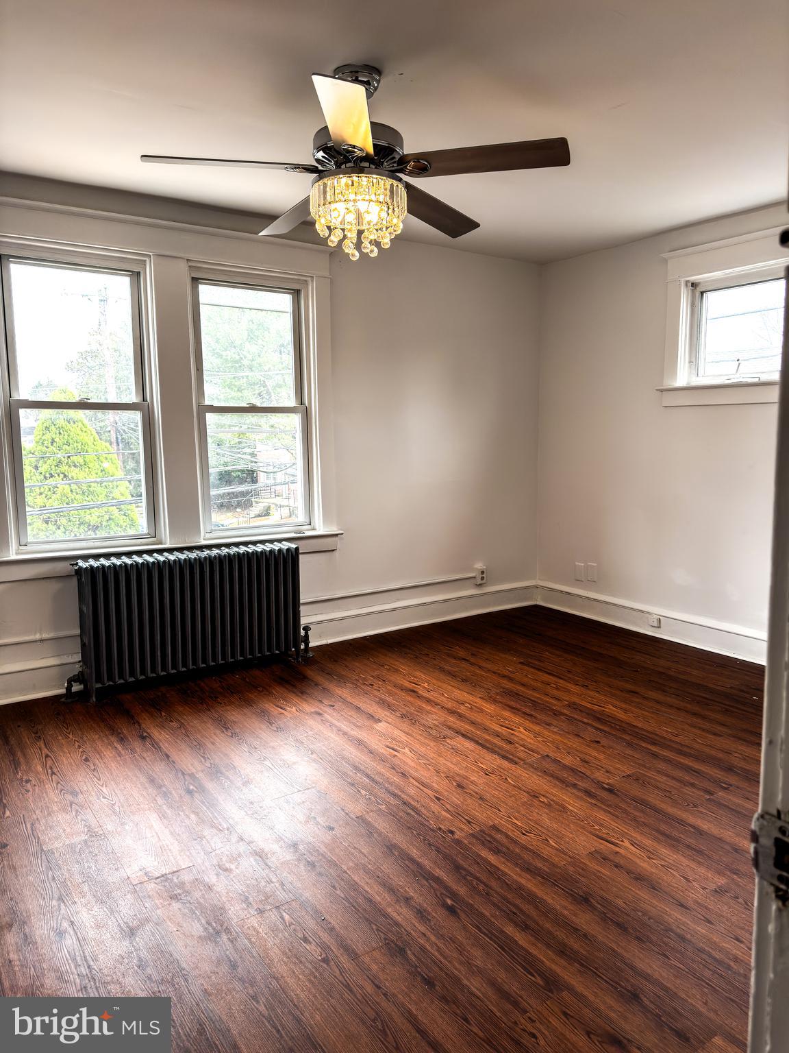 234 Windsor Avenue Upper Darby, PA 19082 - Photo 3 of 28 a view of an empty room with wooden floor and a window