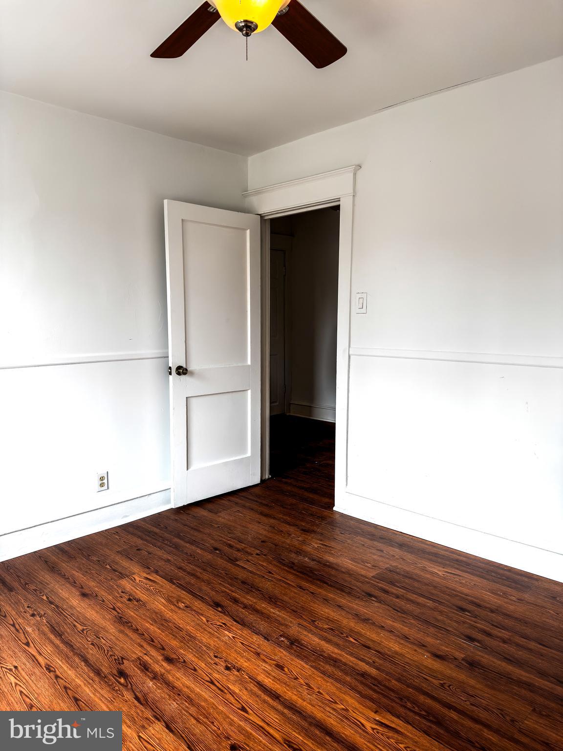 234 Windsor Avenue Upper Darby, PA 19082 - Photo 4 of 28 a view of a room with wooden floor and a ceiling fan