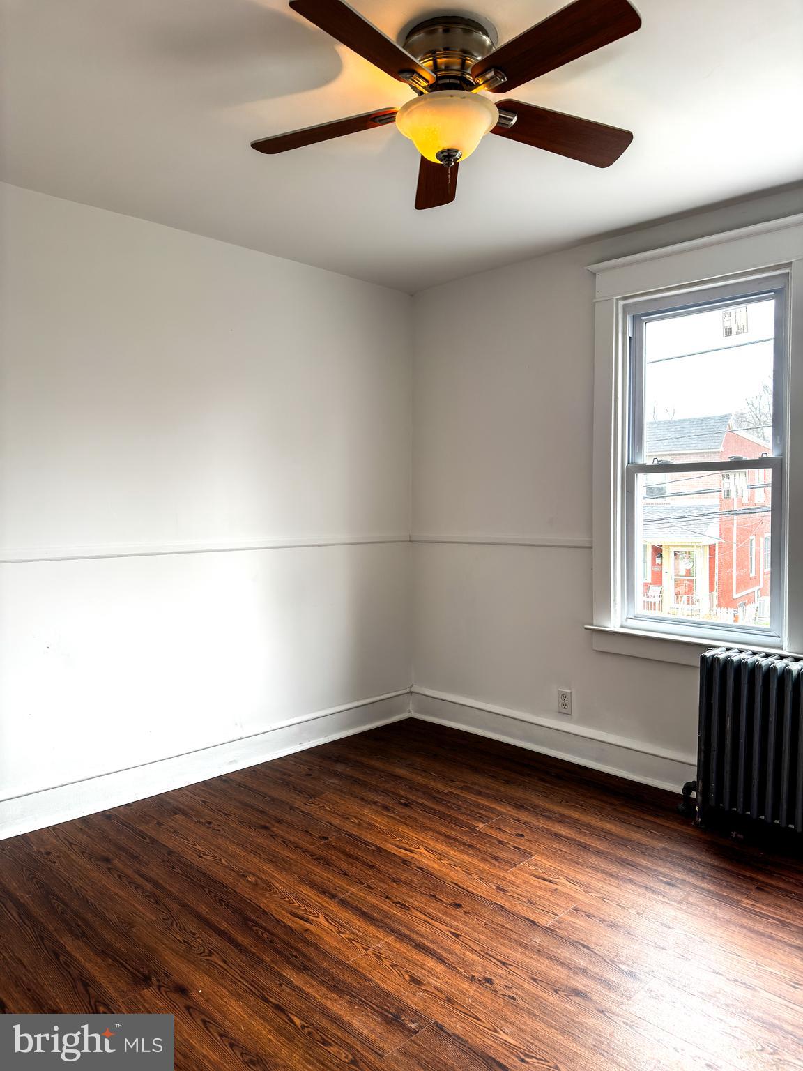 234 Windsor Avenue Upper Darby, PA 19082 - Photo 5 of 28 a view of empty room with wooden floor