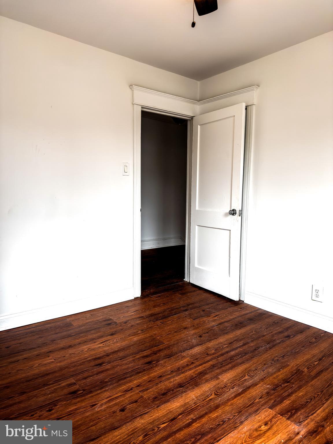 234 Windsor Avenue Upper Darby, PA 19082 - Photo 6 of 28 a view of an empty room with wooden floor