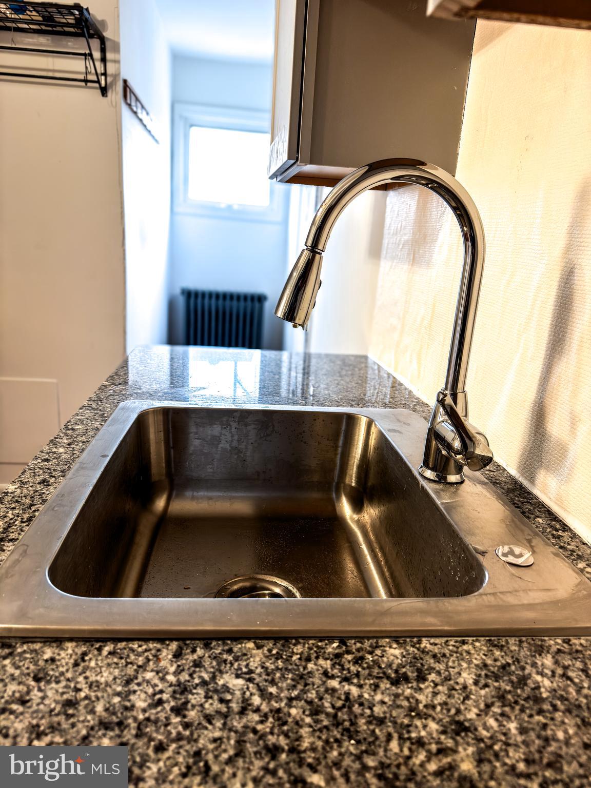 234 Windsor Avenue Upper Darby, PA 19082 - Photo 8 of 28 a bathroom with a granite countertop sink a mirror and bathtub