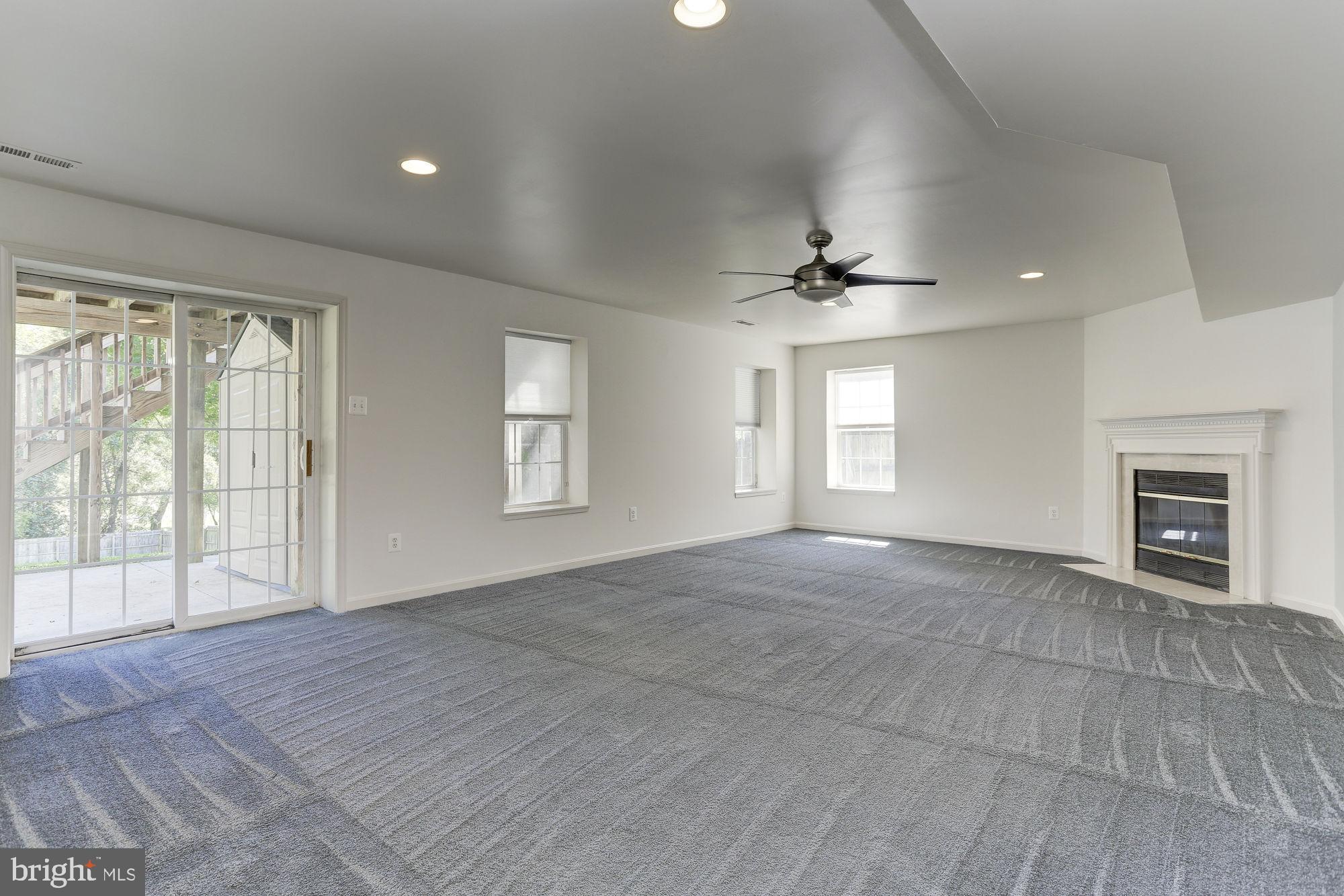10689 Stansfield Road Laurel, MD 20723 - Photo 35 of 52 Lower level rec room with wood burning fireplace