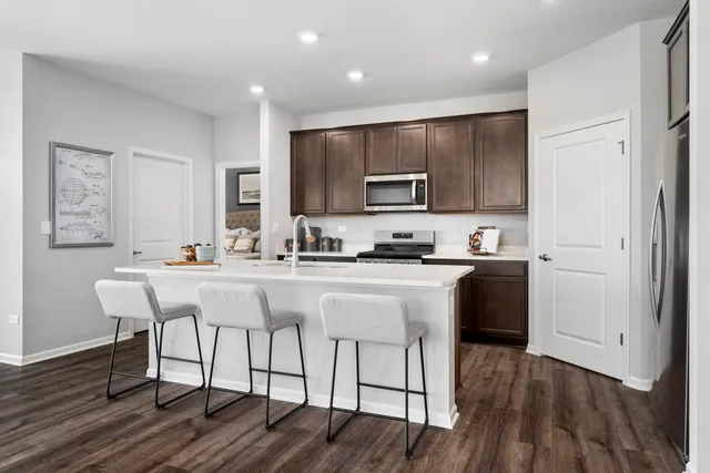 a kitchen with a sink cabinets and wooden floor