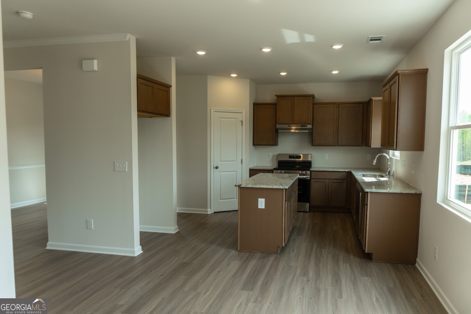 74 Hampton Ridge Way, Unit 39 Jefferson, GA 30549 - Photo 11 of 14 a kitchen with stainless steel appliances granite countertop a refrigerator a sink a stove a microwave and wooden floor