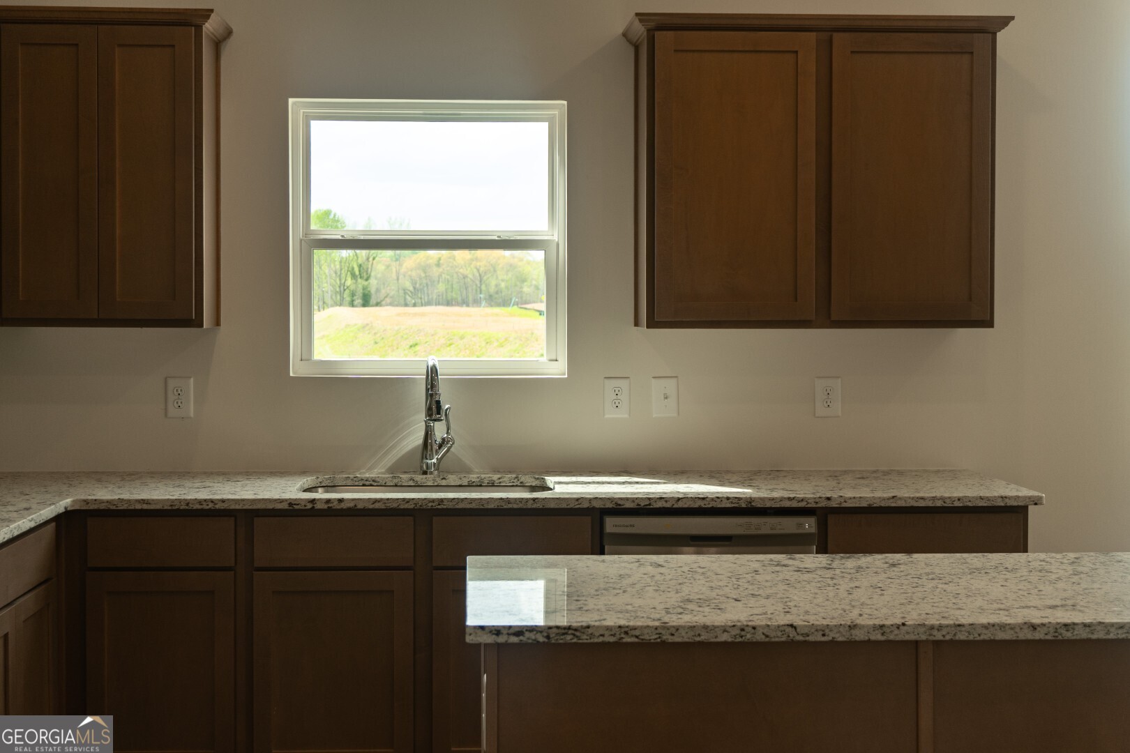 74 Hampton Ridge Way, Unit 39 Jefferson, GA 30549 - Photo 13 of 14 a kitchen with granite countertop cabinets sink and a granite counter top