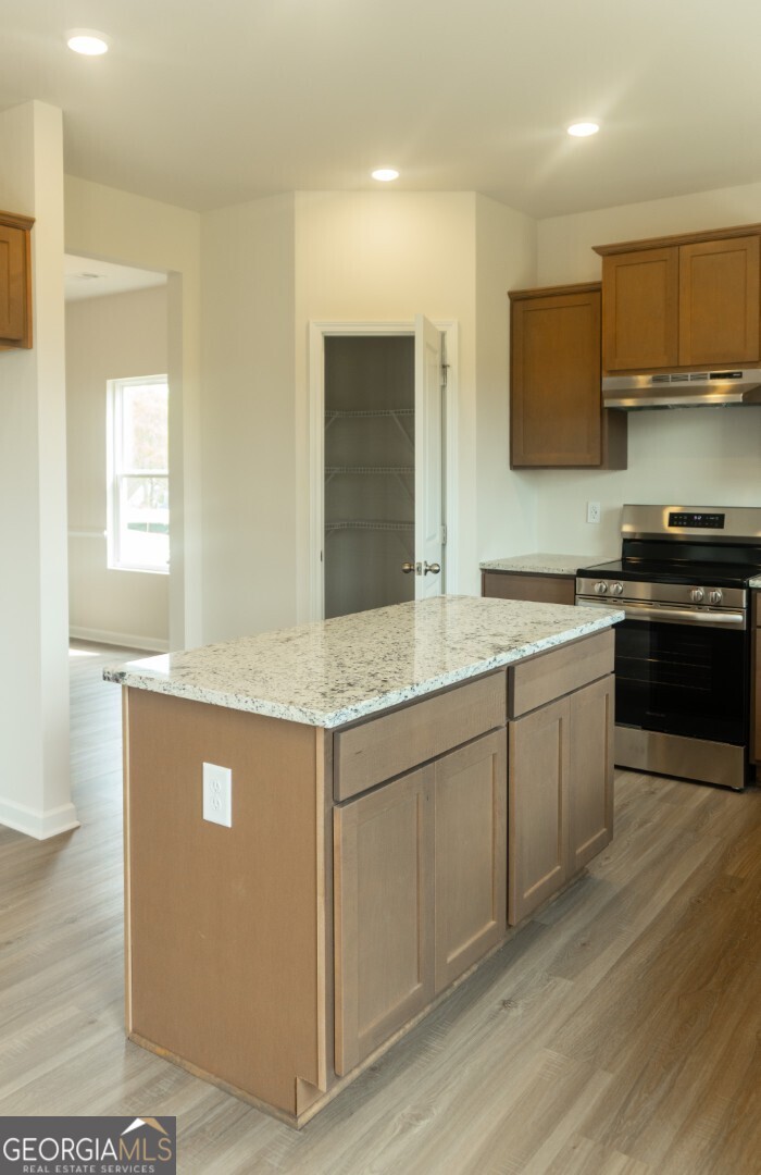 74 Hampton Ridge Way, Unit 39 Jefferson, GA 30549 - Photo 4 of 14 a kitchen with stainless steel appliances granite countertop a stove a sink and a microwave