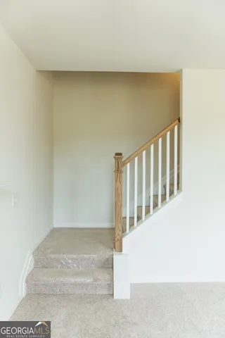 a view of staircase with white walls