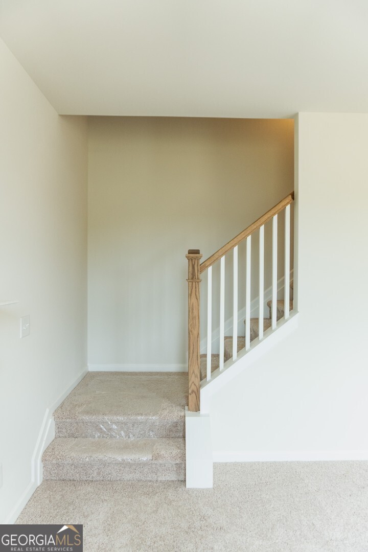 74 Hampton Ridge Way, Unit 39 Jefferson, GA 30549 - Photo 7 of 14 a view of staircase with white walls