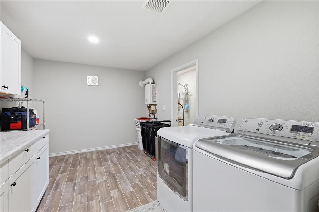 110 Highview Road Ennis, TX 75119 - Photo 21 of 40 Utility room featuring wood-finish flooring, white cabinetry with dark hardware, and a light-toned countertop