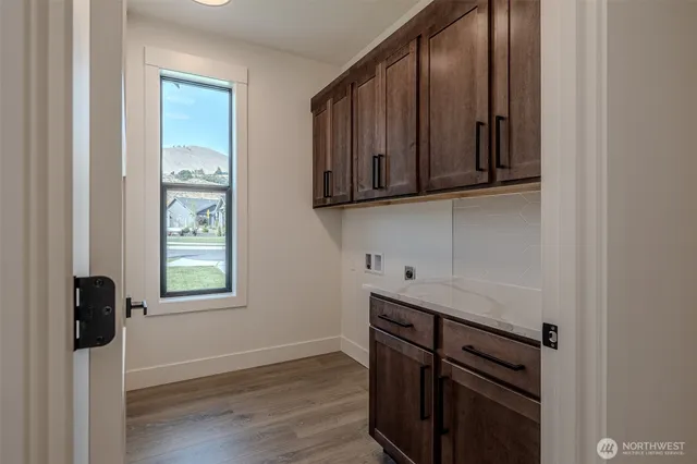 a view of a storage and utility room in wooden floor