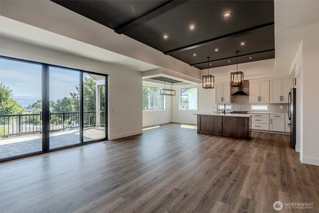 a view of a livingroom with wooden floor and furniture