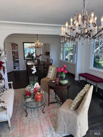 a living room with furniture and flowers