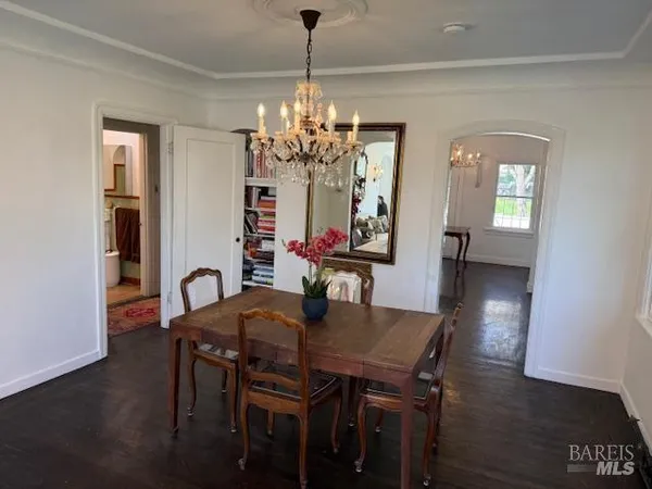 a view of a dining room with furniture and chandelier