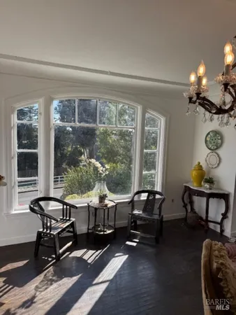 a living room with furniture and floor to ceiling windows